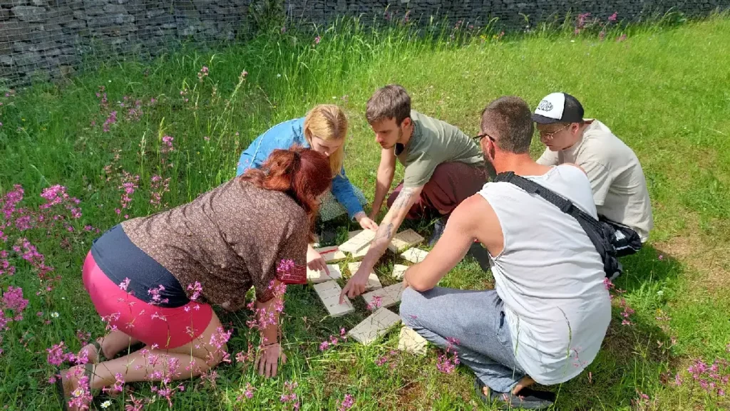 Tím rieši logickú úlohu v prírode počas teambuildingu vo forme outdoor šifrovacej hry